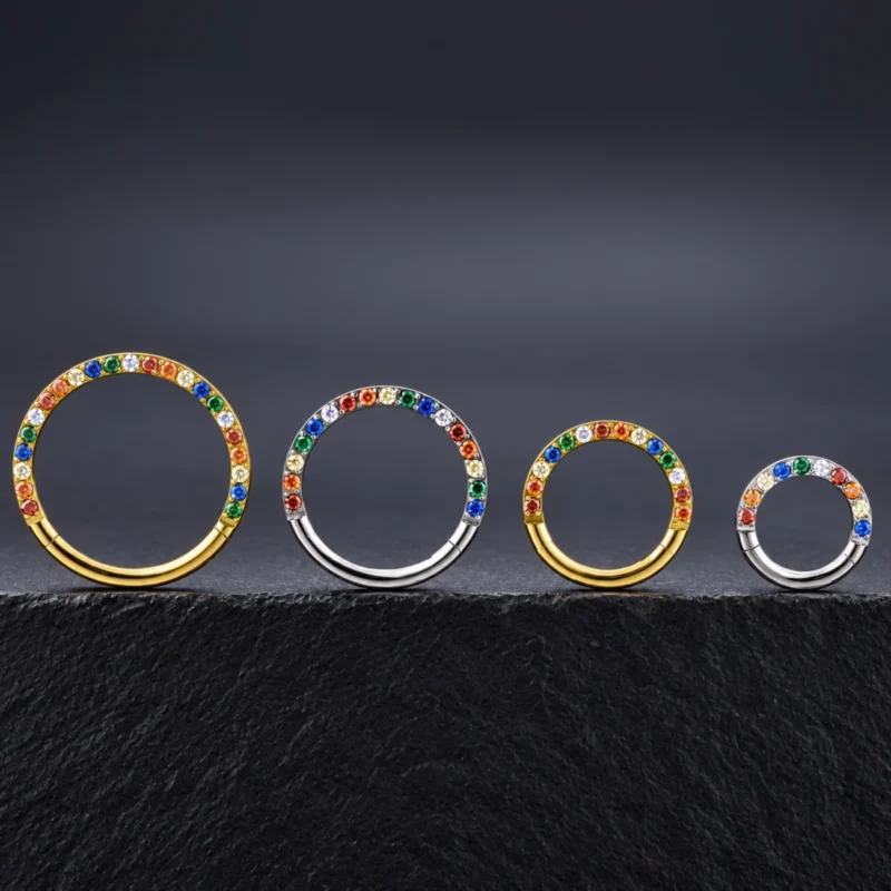 Aro clicker Temis Colores de titanio con piedras de colores, en dorado y plateado