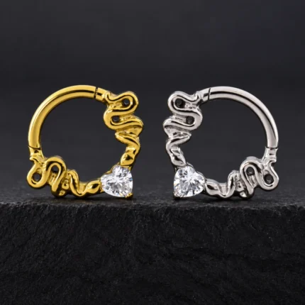 Aros clicker de titanio dorado y plateado con dos serpientes y circón blanco en forma de corazón
