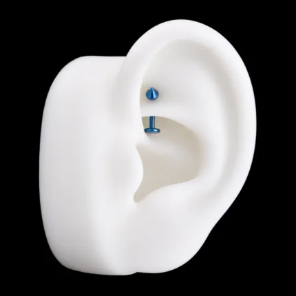 Barra curva azul con spike puesta en piercing rook